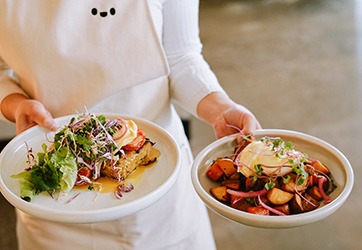Chef Holding Two Prepared Dishes