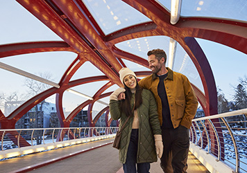 Couple Walking Across Peace Bridge